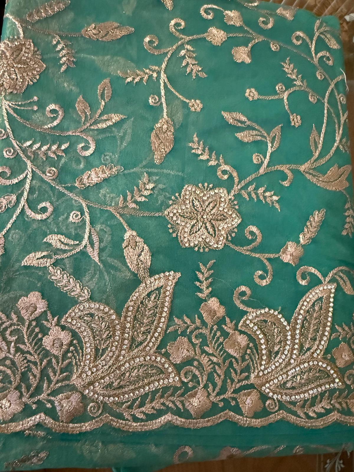 Tissue organza saree with gold zarkan embroidery with attached embroidered blouse piece and petticoat included
