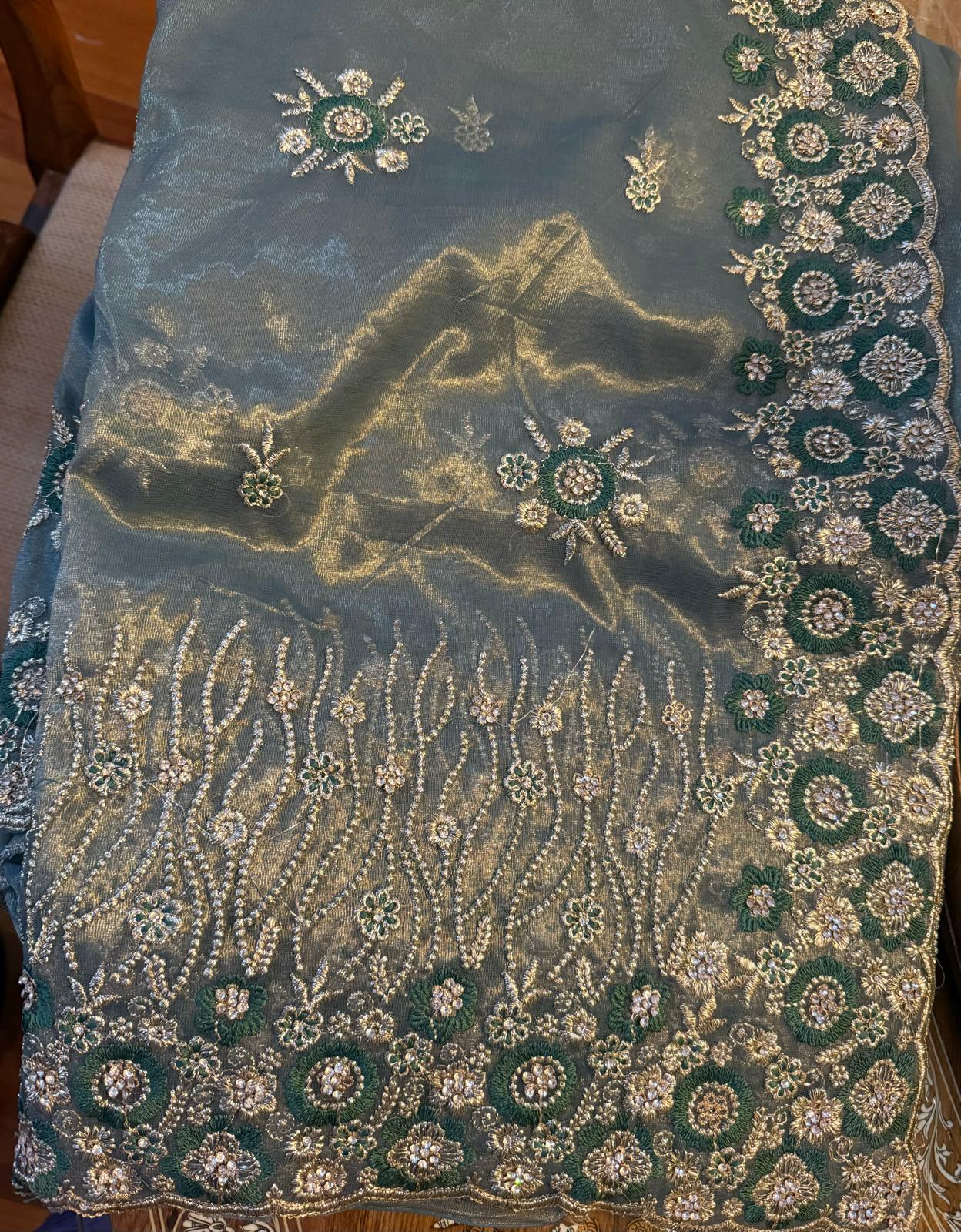 Tissue net saree with gold zarkan contrast embroidery with attached embroidered blouse piece and petticoat included