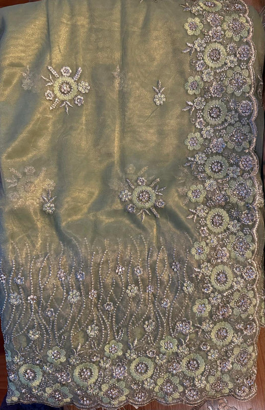 Tissue net saree with gold zarkan contrast embroidery with attached embroidered blouse piece and petticoat included