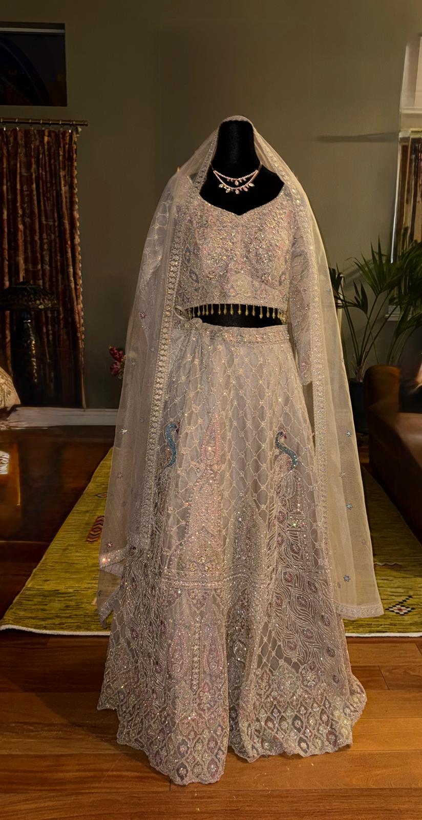 Beige net lehenga with pearl gold zarkan peacock embroidery with designer blouse