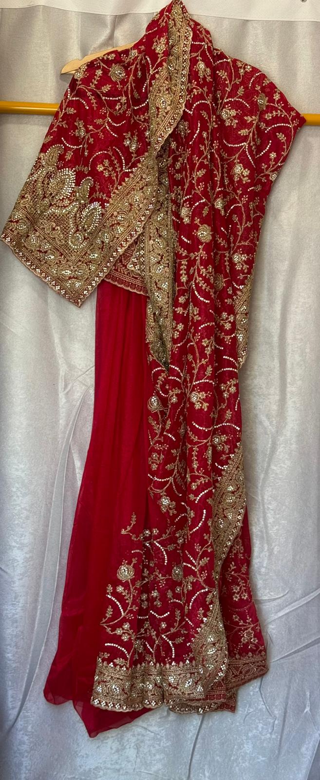 Heavy tissue net saree with gold thread embroidery and zarkan work with matching petticoat and attached blouse piece