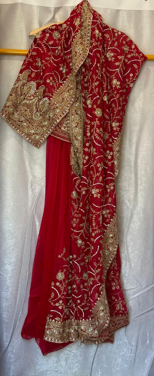 Heavy tissue net saree with gold thread embroidery and zarkan work with matching petticoat and attached blouse piece