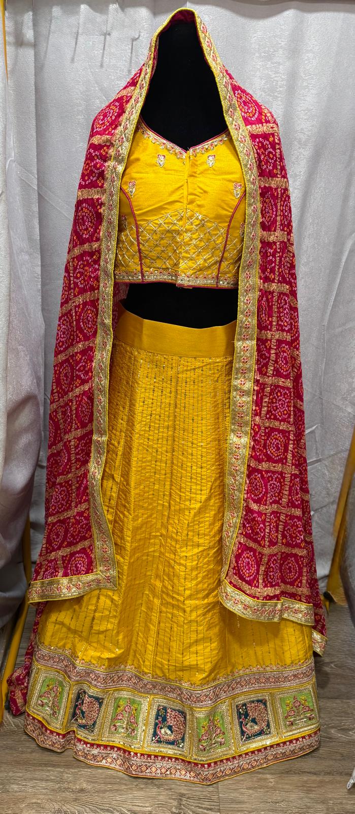 Yellow silk sequence peacock motif lehenga with pink bandani dupatta